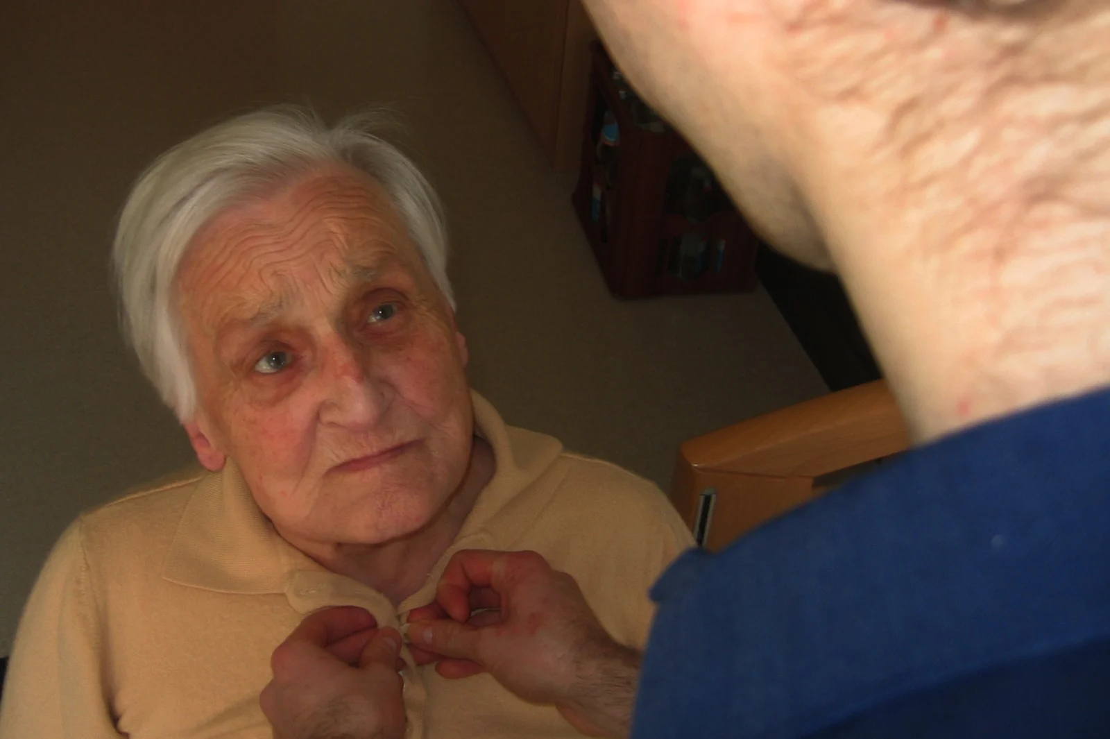 A care professional assisting an older adult